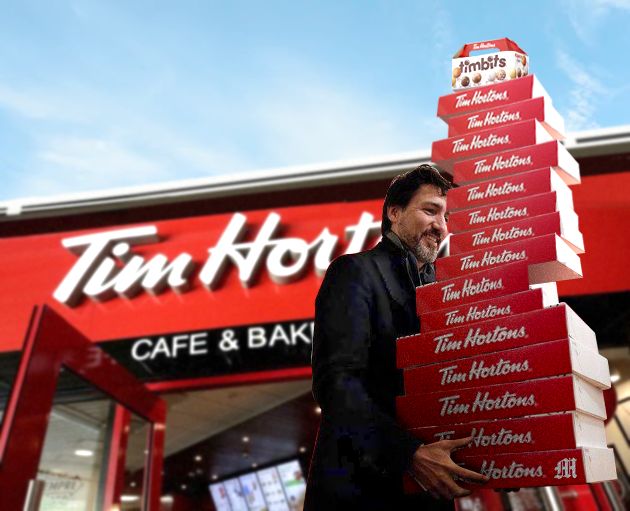 Canadian Prime Minister Justin Trudeau carrying boxes of Tim Hortons doughnuts
